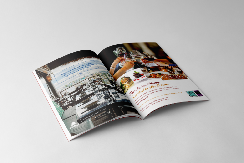 Magazine opened with an ad for The Dock at Crayton cove on the left (featuring a table view on a patio by the water) and an ad for Angelina's Ristorante on the right (featuring 4 individuals hands clinking wine glasses).