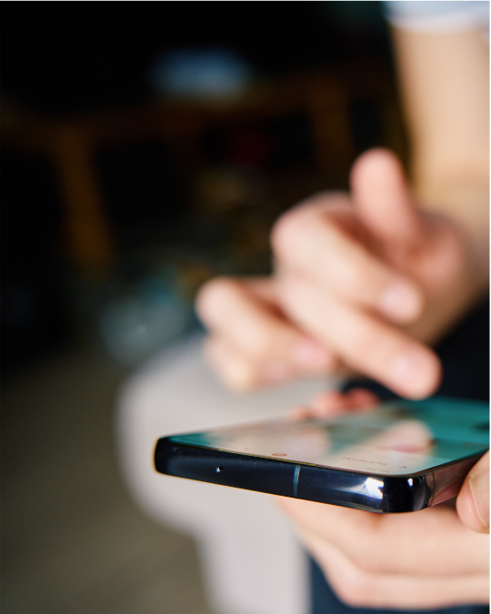 Image of a person scrolling on their iPhone