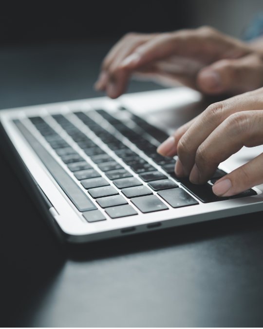 A person typing on a computer