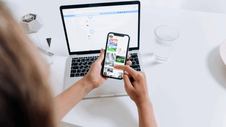 Woman holding an iPhone in front of a computer, decorative blog image