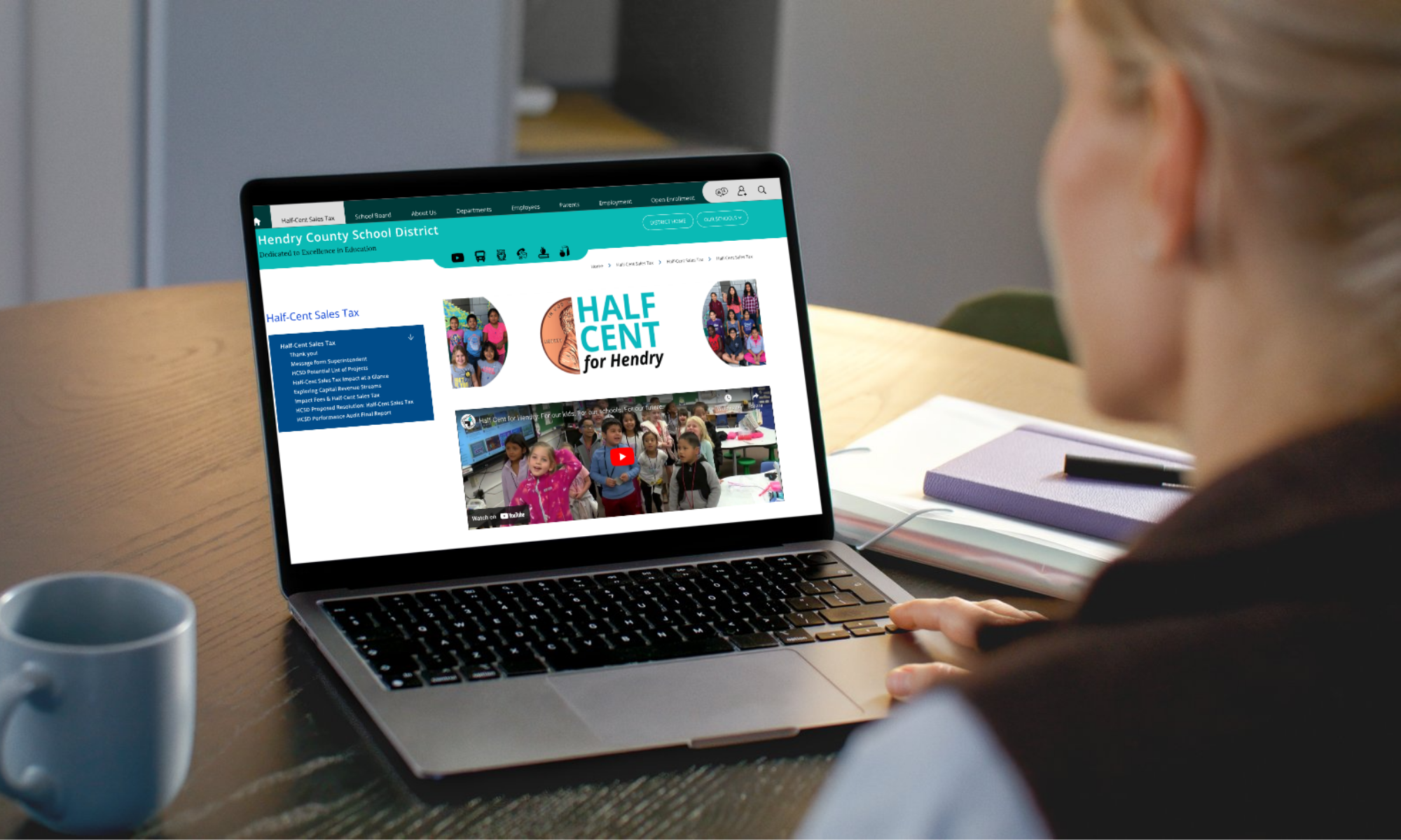 Laptop screen mockup displaying the Half Cent for Hendry campaign landing page